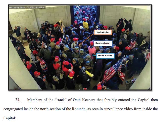 Arrows point to Sandra Parker, Donovan Crowl, and Jessica Watkins all wearing tactical gear in the middle of a large crowd inside the Capitol