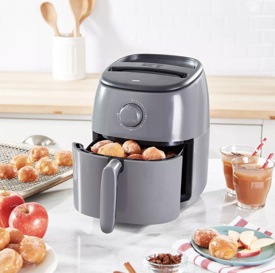 the air fryer in dark gray with donuts in it