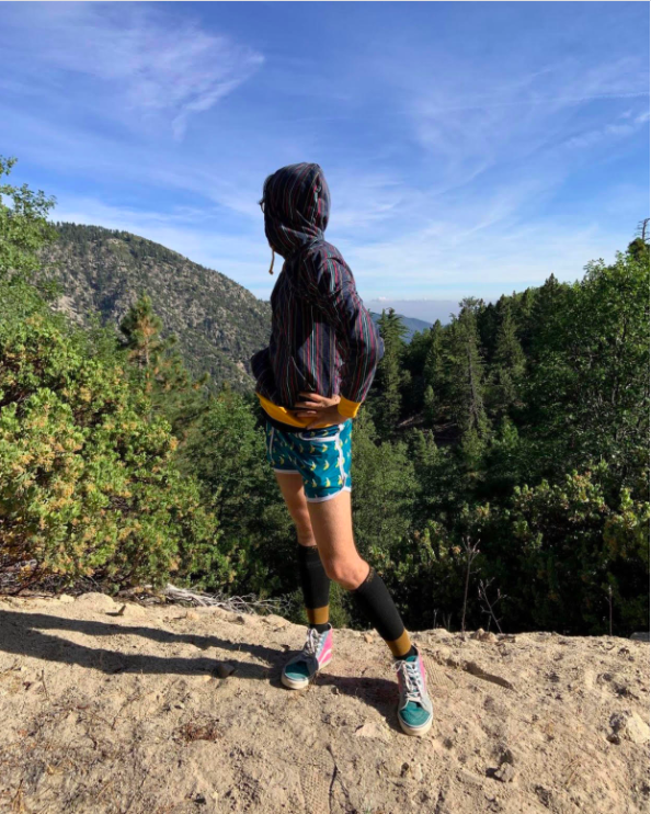 the author wearing the banana shorts on a mountainside