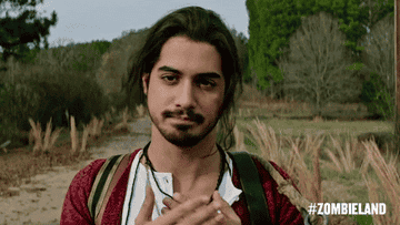 Avan Jogia clasps his hands over his heart, smiles, and nods