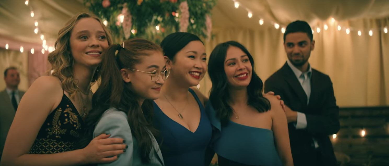 LJ, her sisters and Chris smile in the wedding tent while holding onto each other