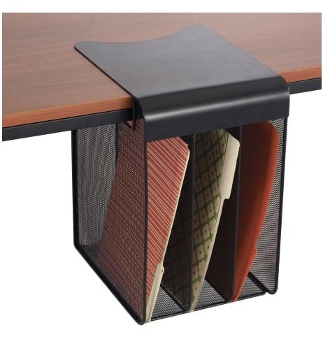 the black mesh wire organizer hanging off a table and holding a file folder in each compartment