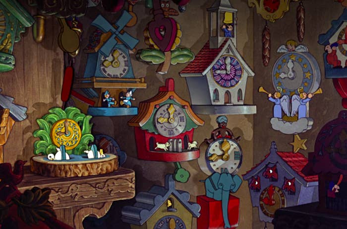 several impossible-looking cuckoo clocks hang on the workshop wall