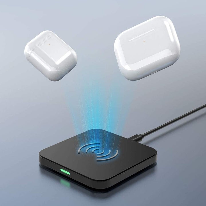 Airpods being placed on the charging pad