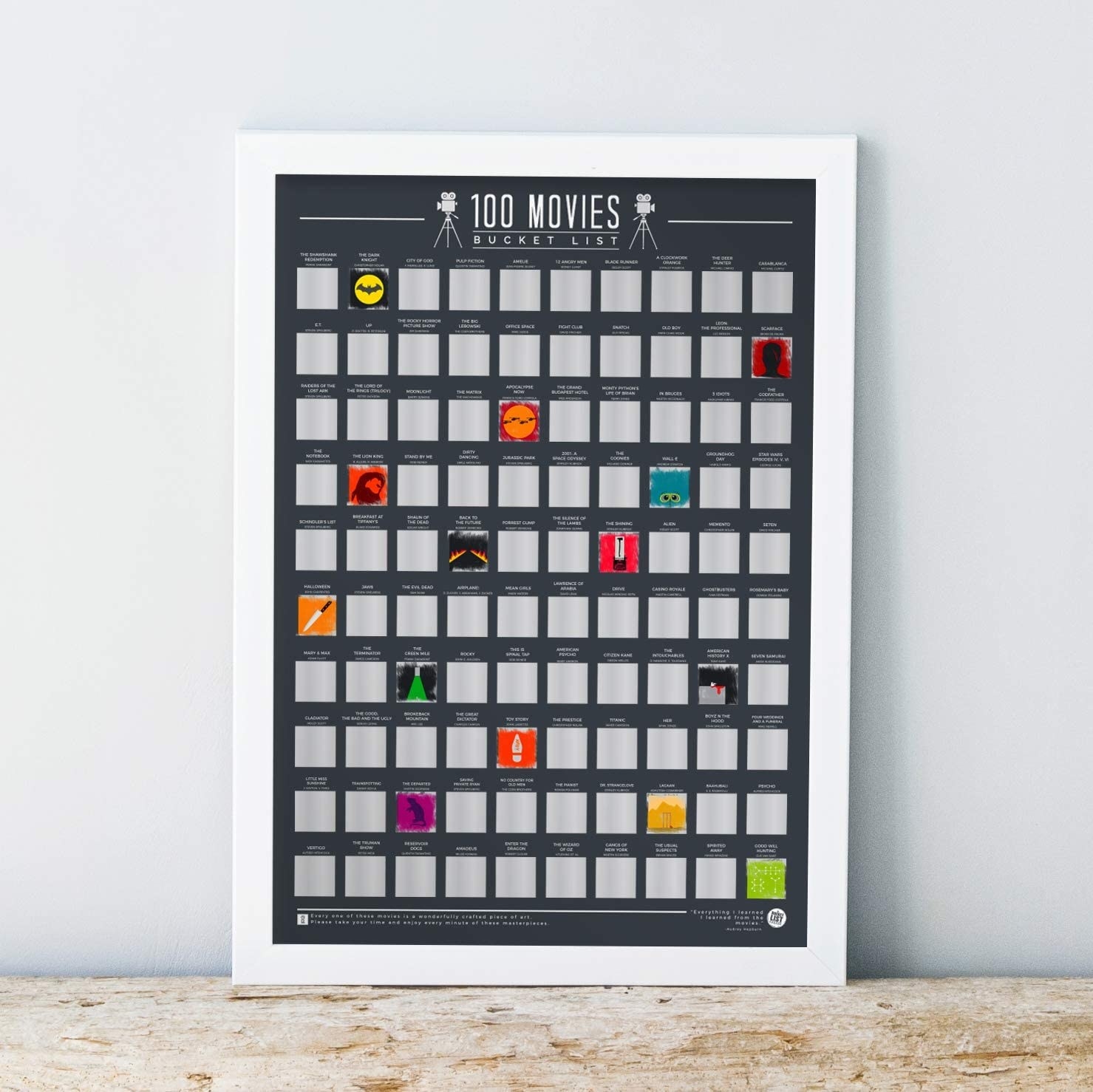 Movie scratch off poster with silver covers on top of colorful posters