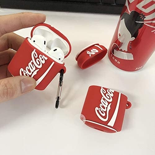 Model holds the red and white CocaCola AirPods case 