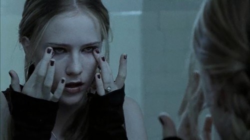 Evan Rachel Wood from 13 looking sad in a mirror.