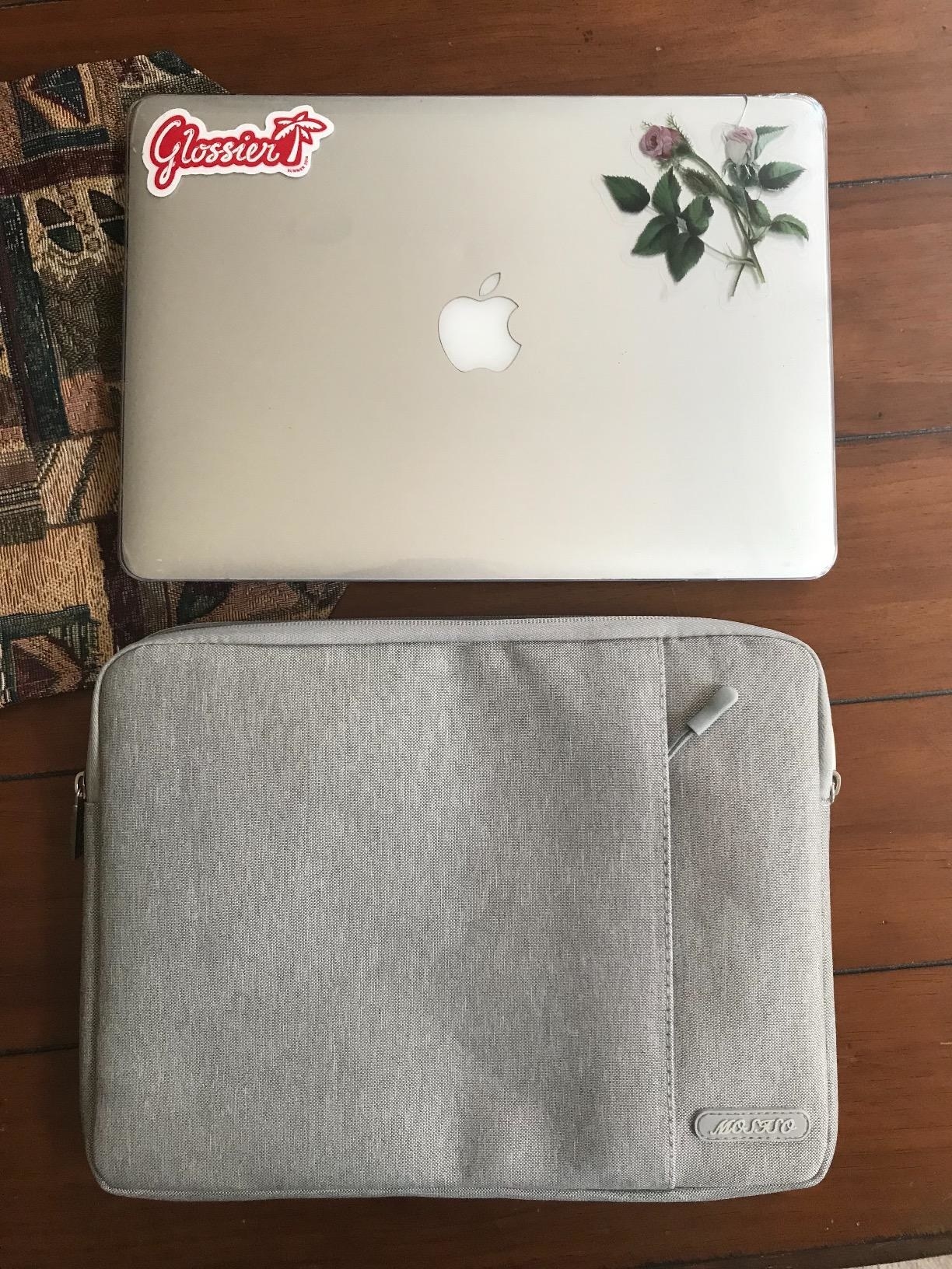 Reviewer&#x27;s photo of their silver iMac laptop beside the gray laptop case
