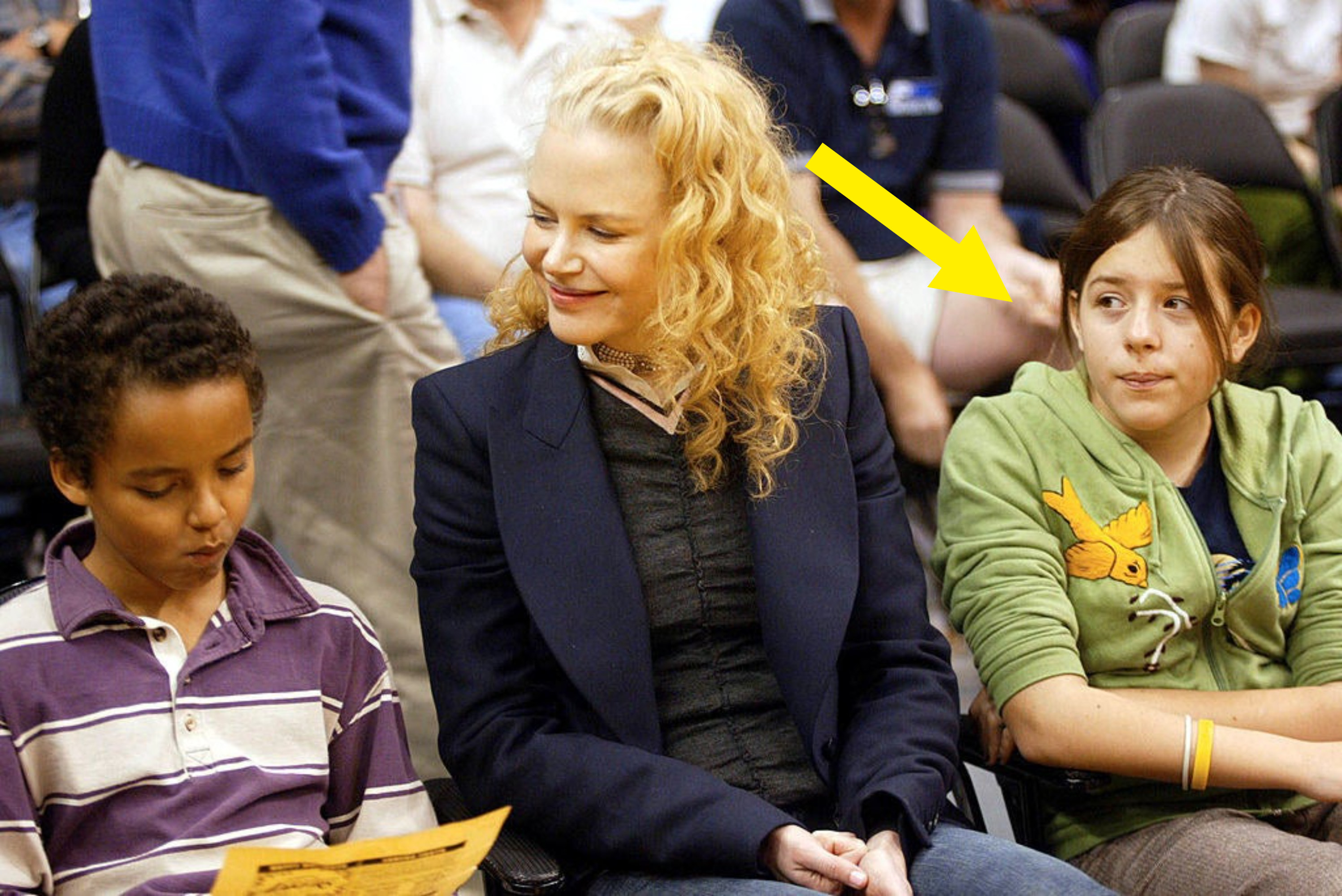 Arrow pointing to Bella sitting with Mason and Nicole