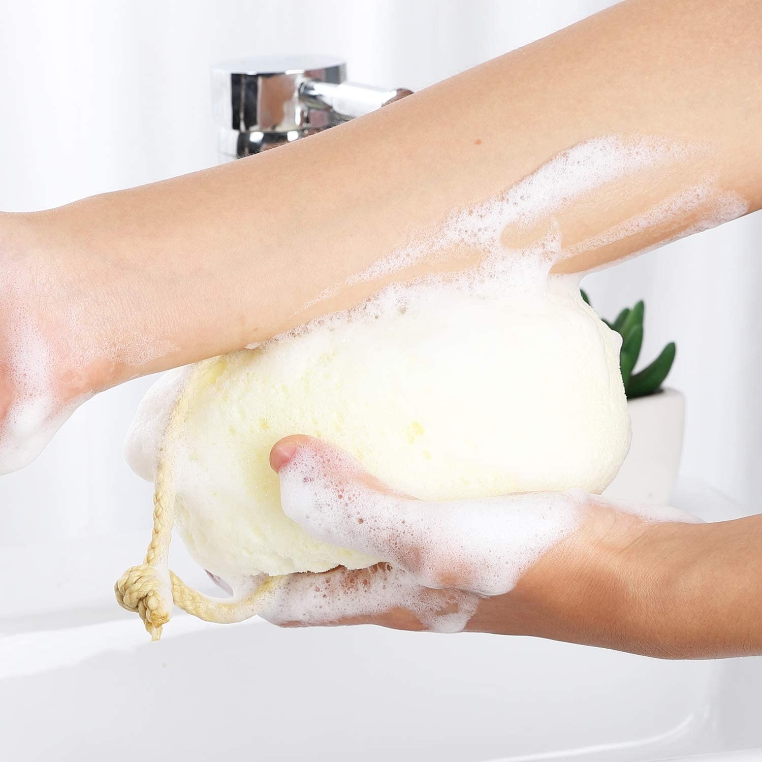 A person scrubbing their arm with the loofah