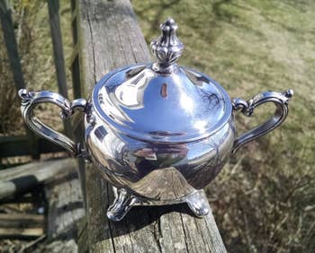 reviewer image of the same teapot, now clean and silver after being polished