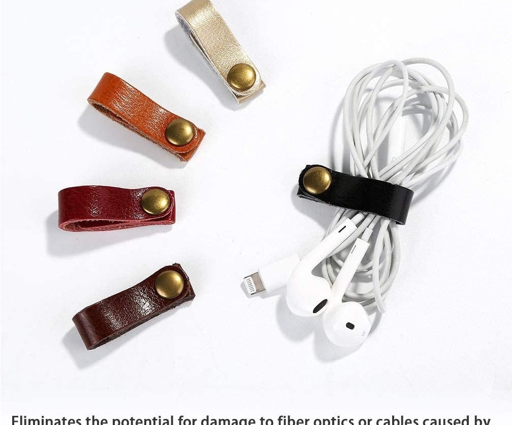thin leather straps that snap at the end with one wrapped around a set of ear buds 