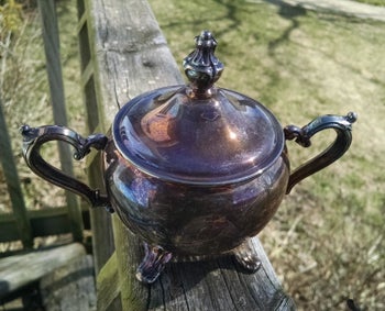 reviewer image of a teapot so tarnished it looks black