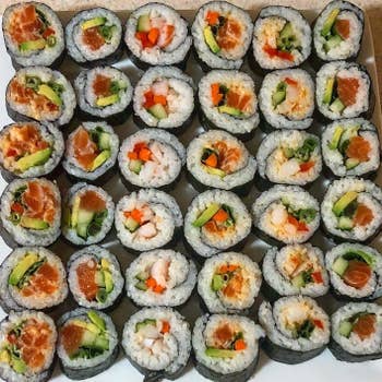 Colorful plate of sushi rolls with fish, avocado, and seaweed made by reviewer