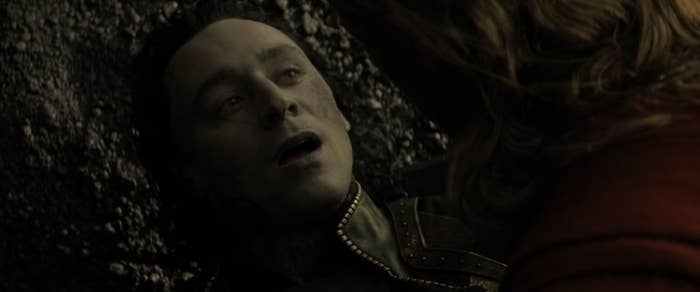 Loki gasping while Thor looks over him in &quot;Thor: The Dark World&quot;