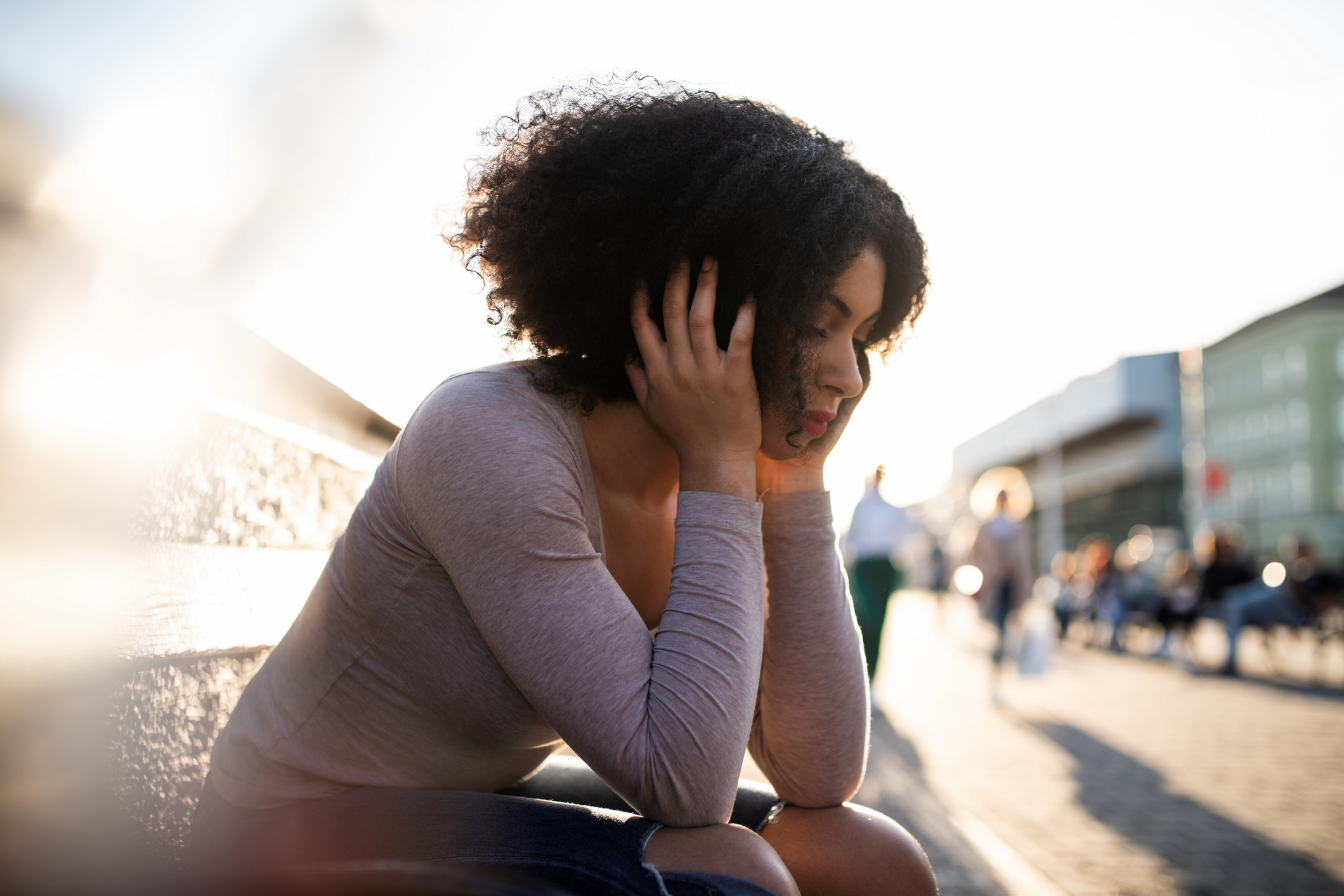 An anguished woman on a bench