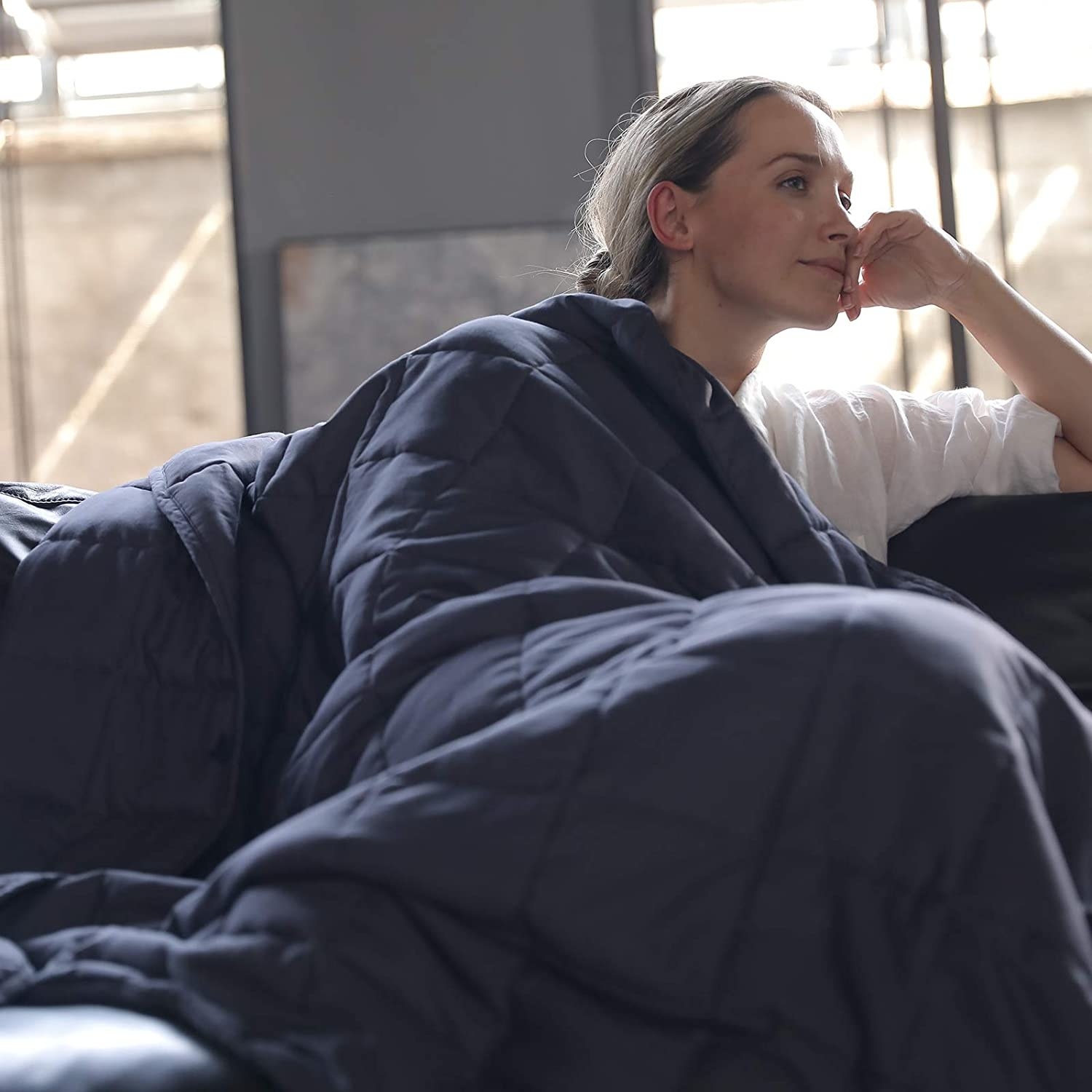 a model with the weighted blanket wrapped around them