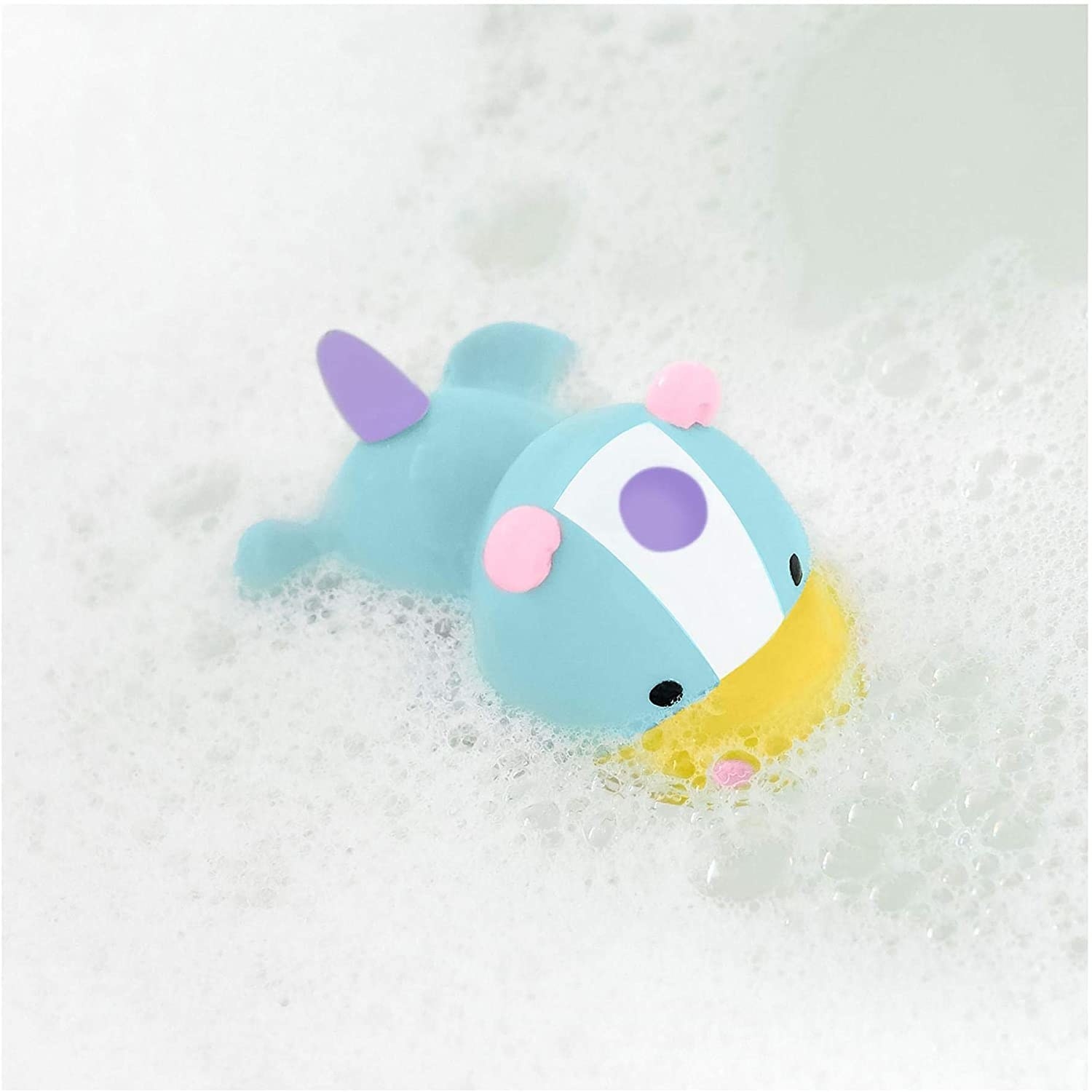 the unicorn toy floating in a bath