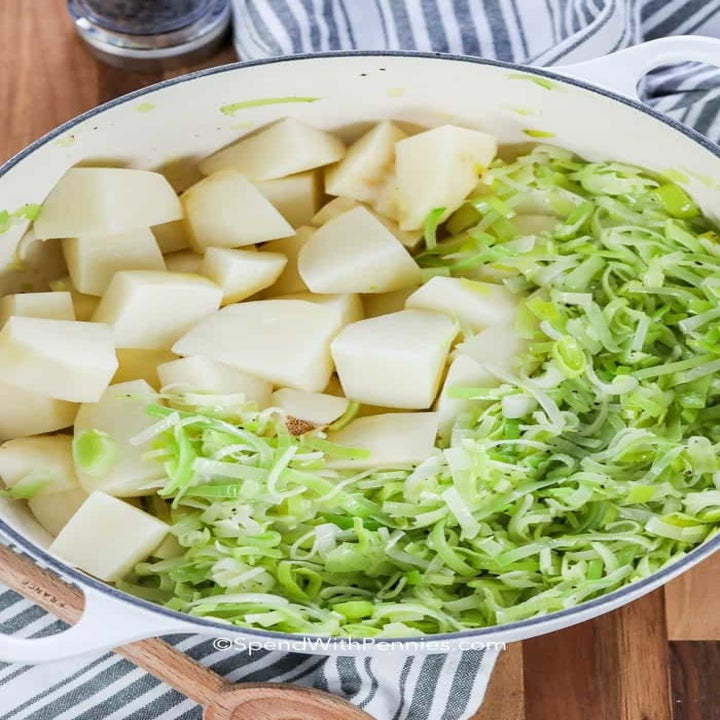 Leeks and potatoes in a soup pot.