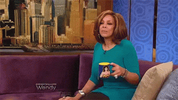 Wendy Williams holding a mug of tea and shaking her head