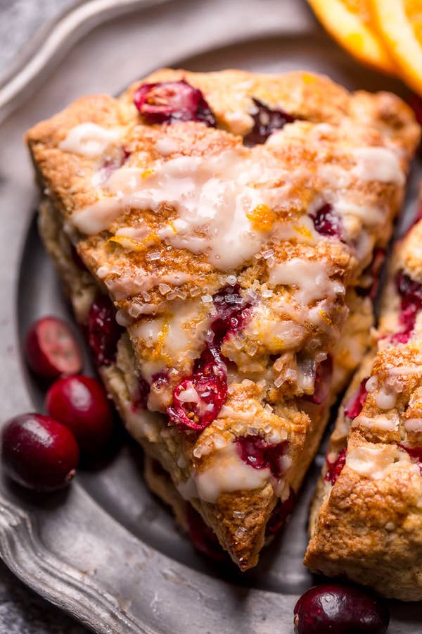 Two cranberry orange scones with icing.
