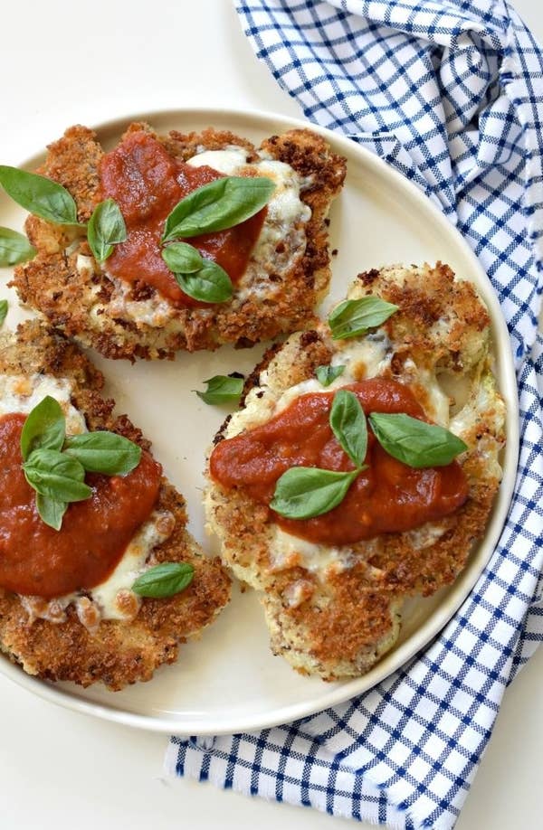 Three pieces of cauliflower parmesan on a plate.
