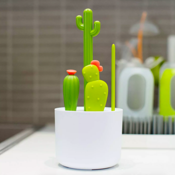 white bowl with four brushes inside that all look like different types of cacti in green
