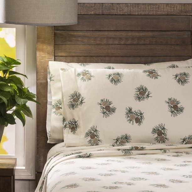 The sheets and pillowcases on a bed, shown in the pinecone pattern
