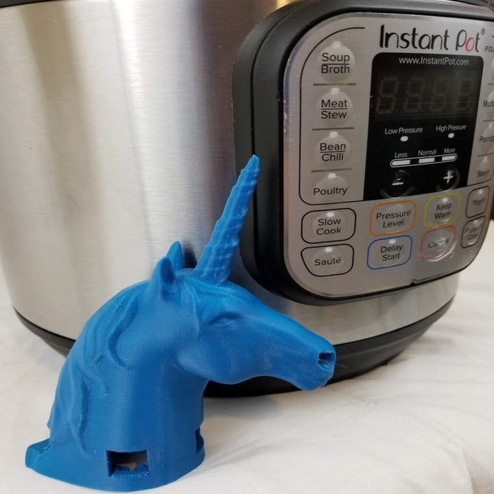 the unicorn attachment sitting next to an instant pot