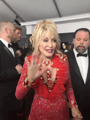 Dolly waving to the camera before walking away on the Grammys red carpet