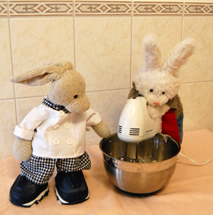 A GIF of two toy rabbits baking.