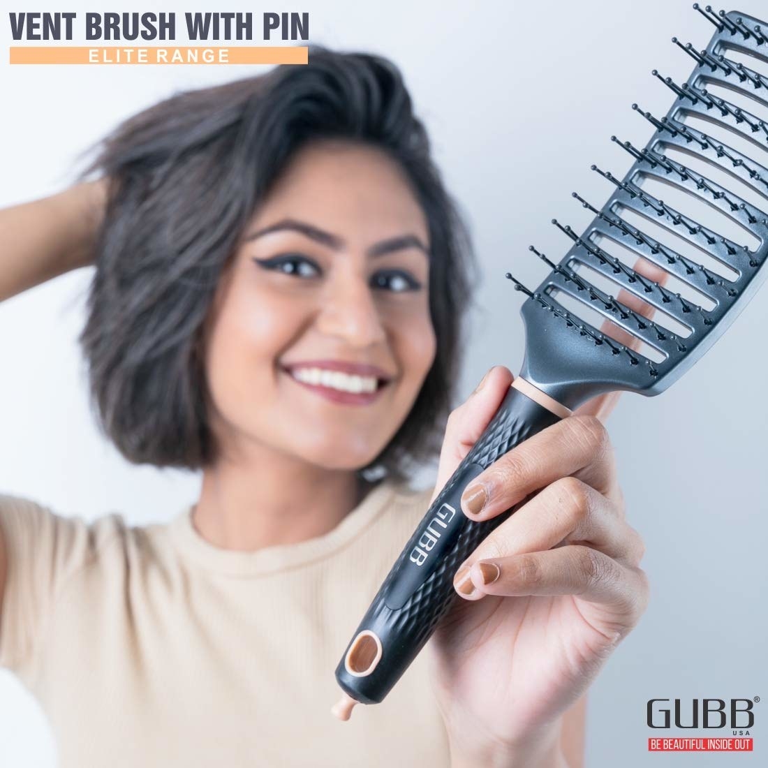 A woman holding the hair detangling brush 