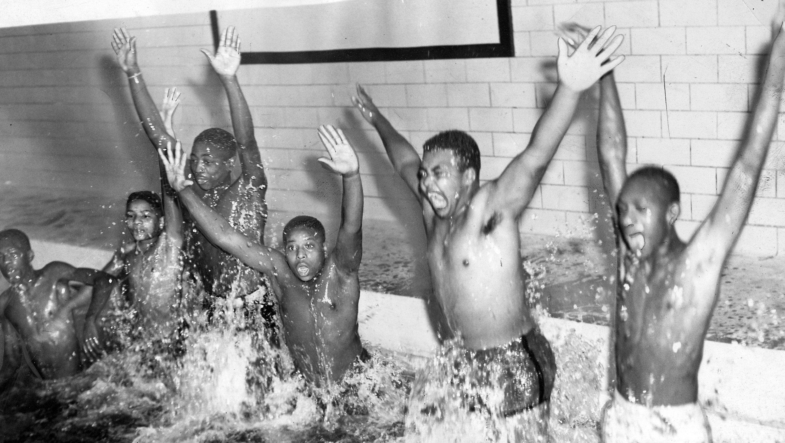 A photo of Black youth swimming in a segregated pool in Baltimore, MD