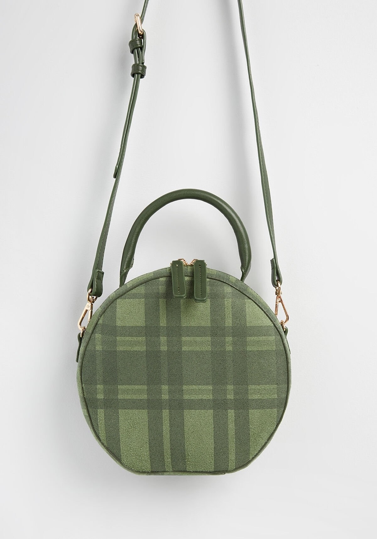 a circular green plaid bag