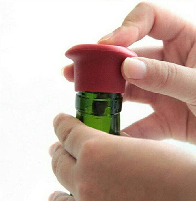 Person closing a wine bottle with the stopper.