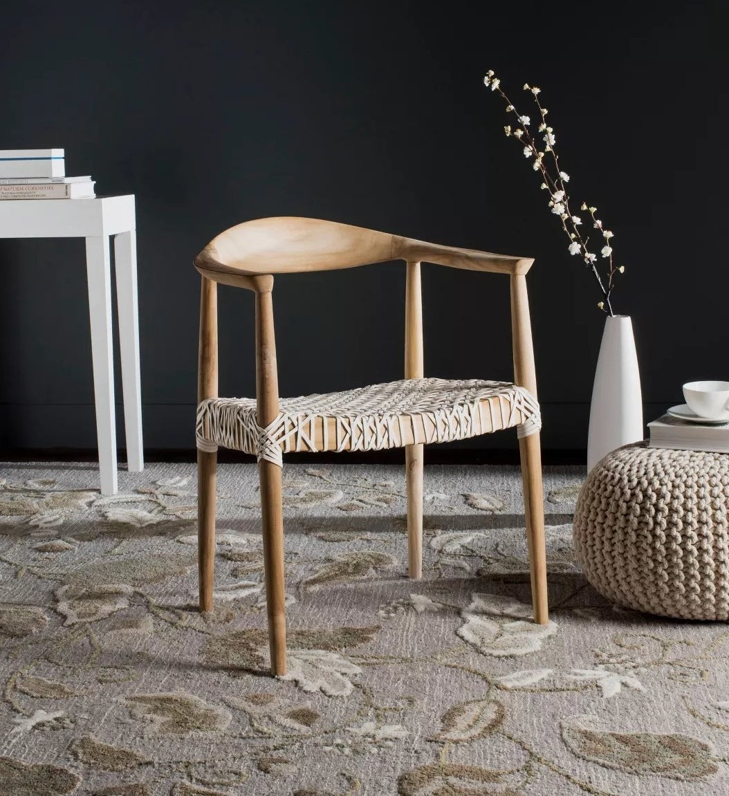 The wooden armchair with strips of leather as upholstery