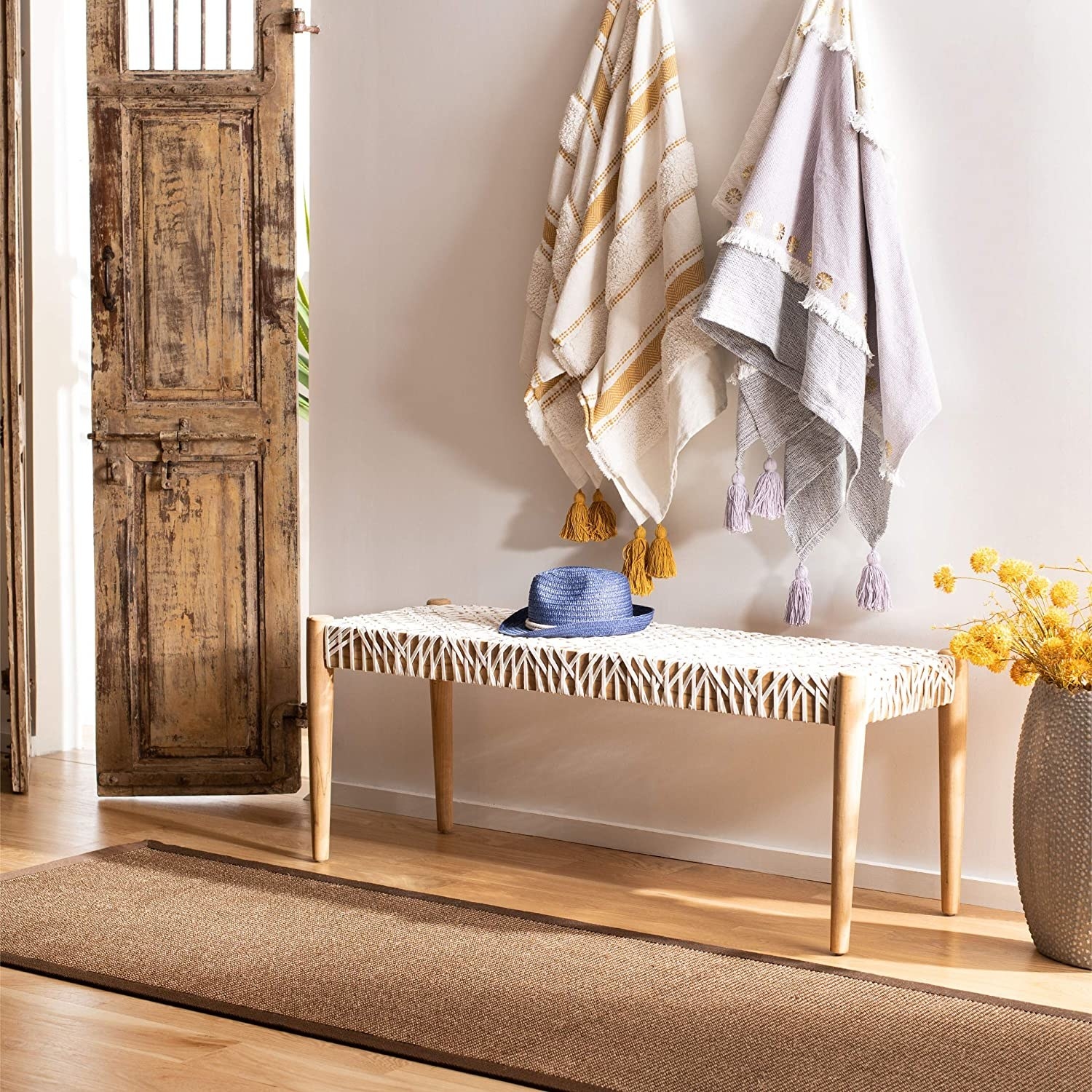 the tan wood bench with a white woven seat