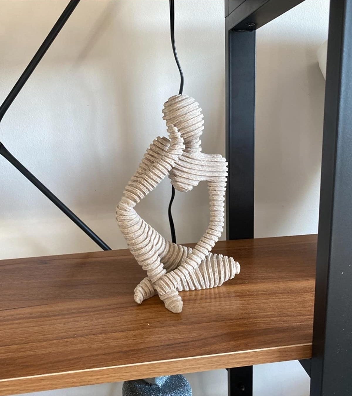 reviewer image of the trycooling thinker statue on a shelf