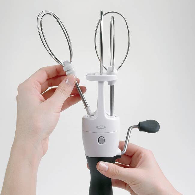 a model using the handheld egg beater