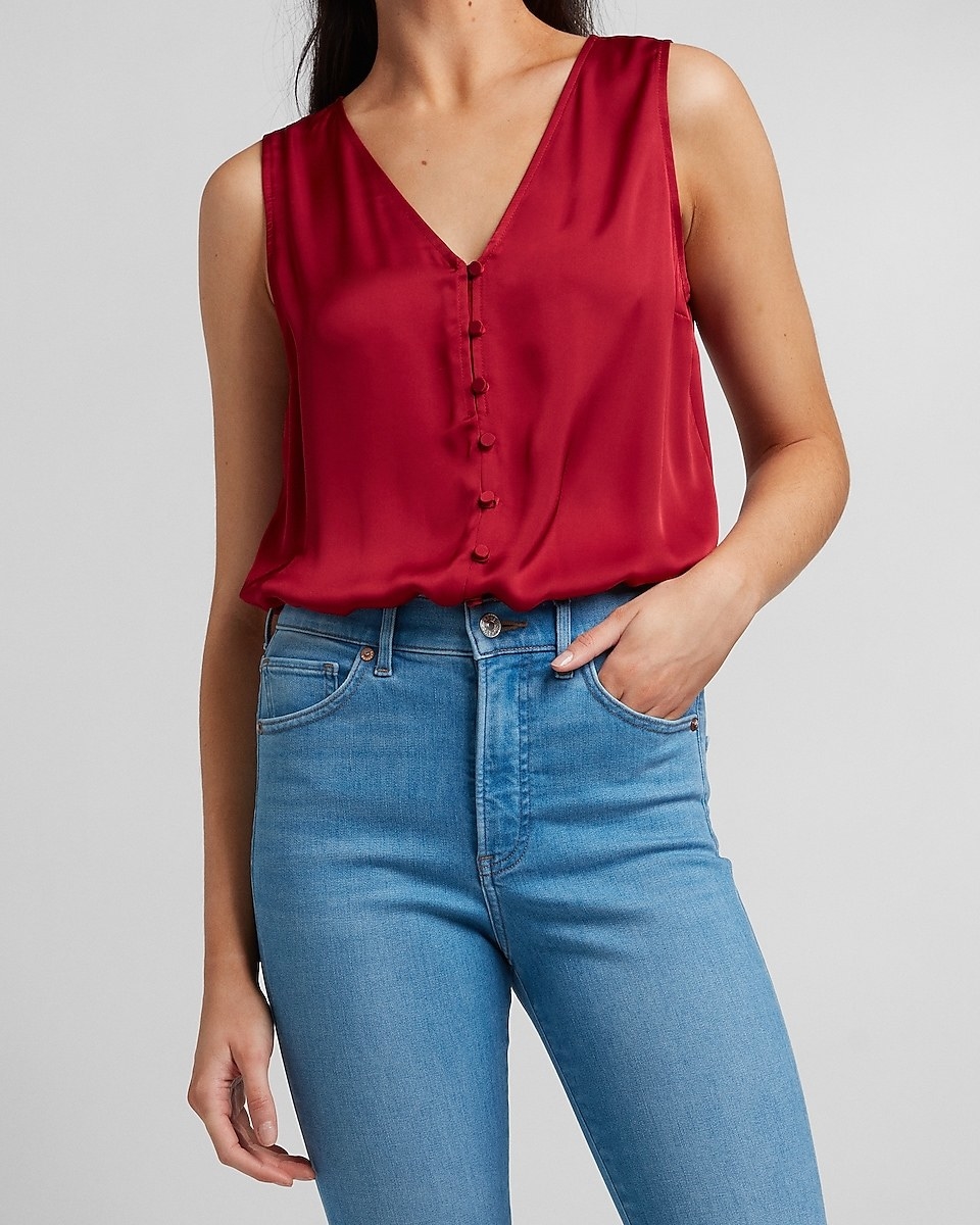 model wearing the bodysuit in pomegranate tucked into jeans