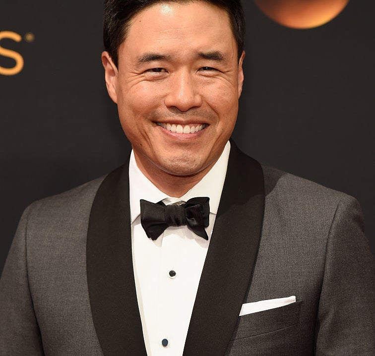 Randall Park wearing a suit and black bow tie at the Emmys red carpet