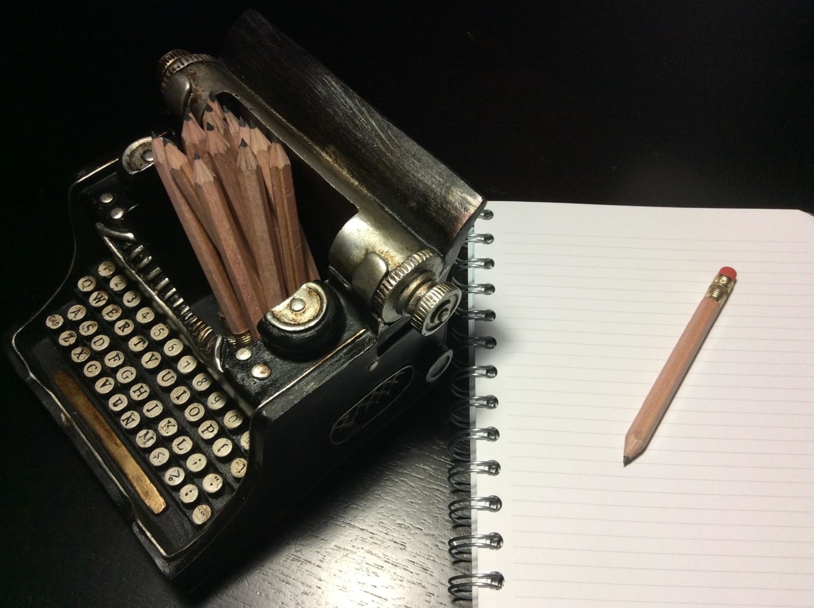 reviewer image of the hemingway pencil cup with pencils stored in it sitting next to a notebook and pencil