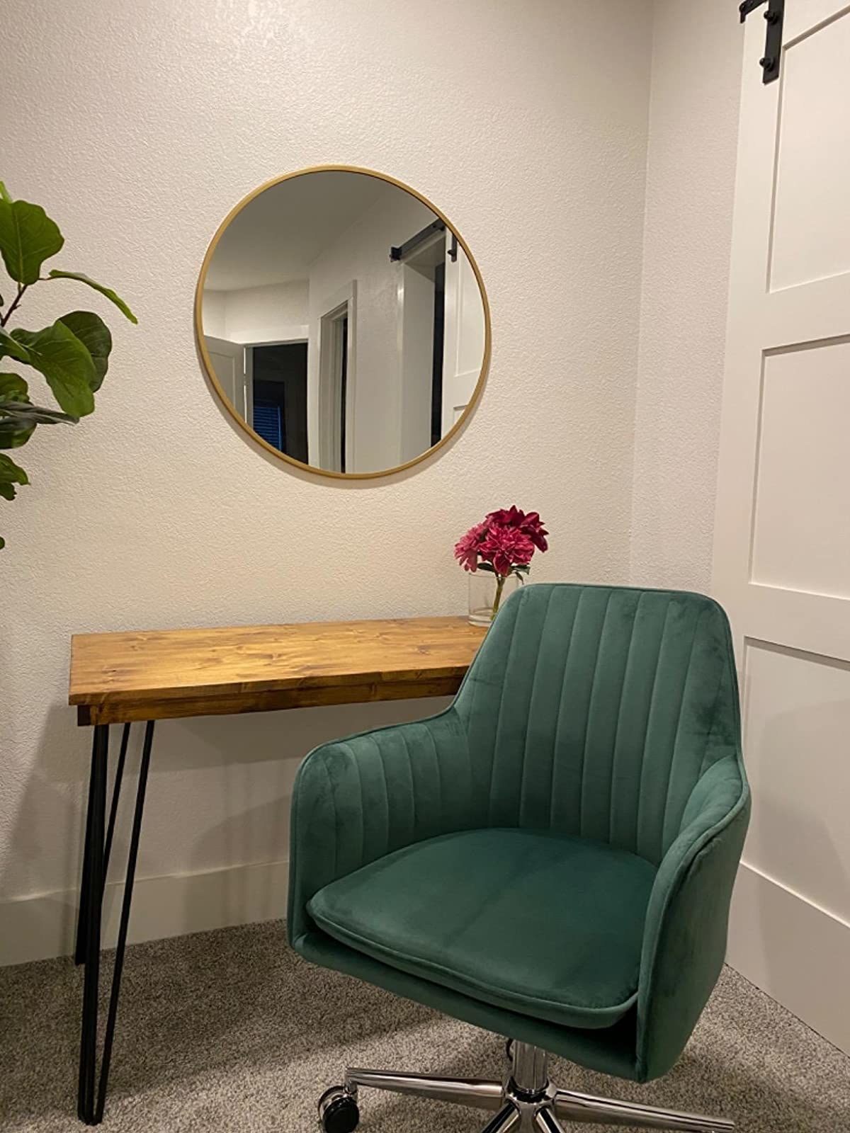 reviewer image of the green ardico velvet desk chair in a living space opposite a small wooden table 