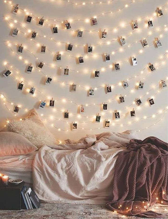rows of Photo Clip String Lights hang above a bed