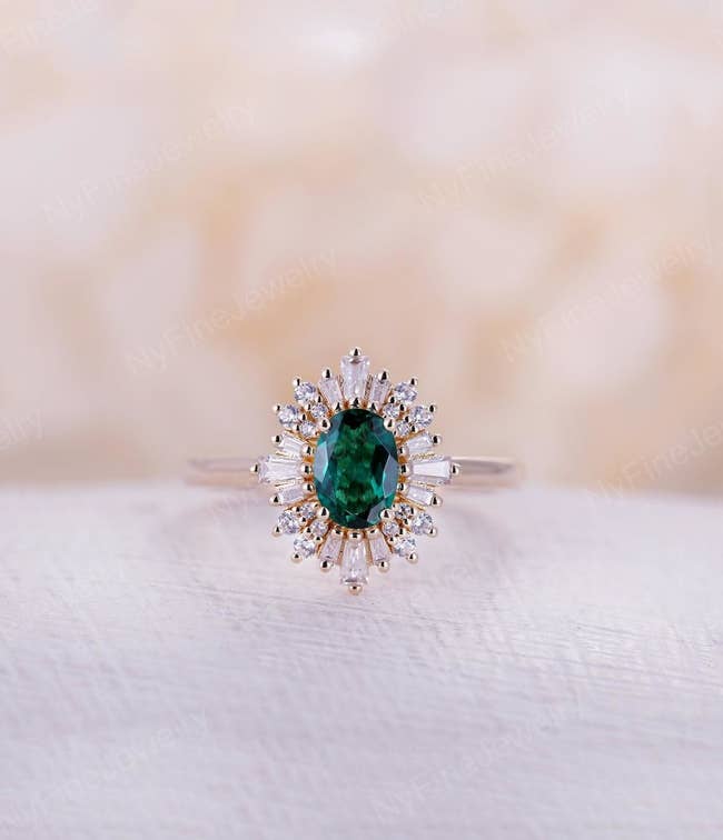 round emerald surrounded by baguette cut stones around the whole thing 
