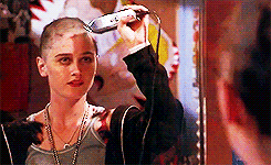GIF of a woman shaving her head