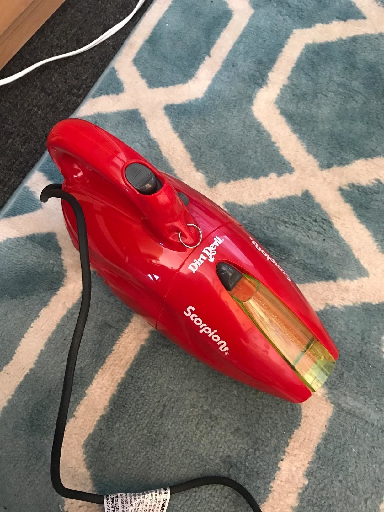 a red handheld dare devil vacuum