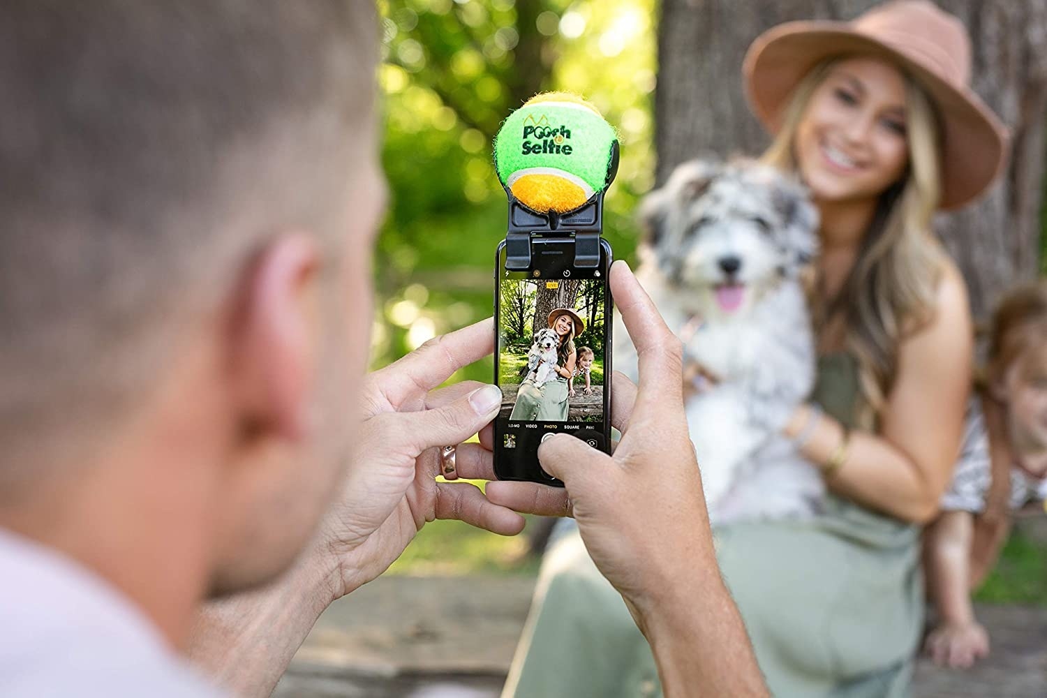 a model posing with a dog for a photo taken with the pooch selfie