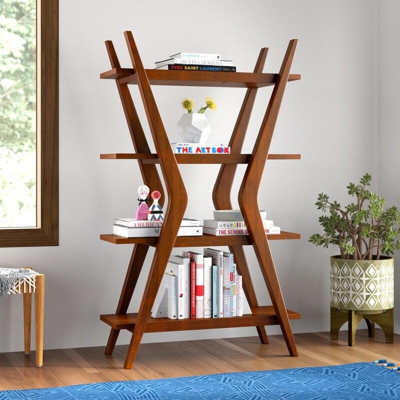 the Lukas Etagere Bookcase in a living space with books stacked on each of its four tiers