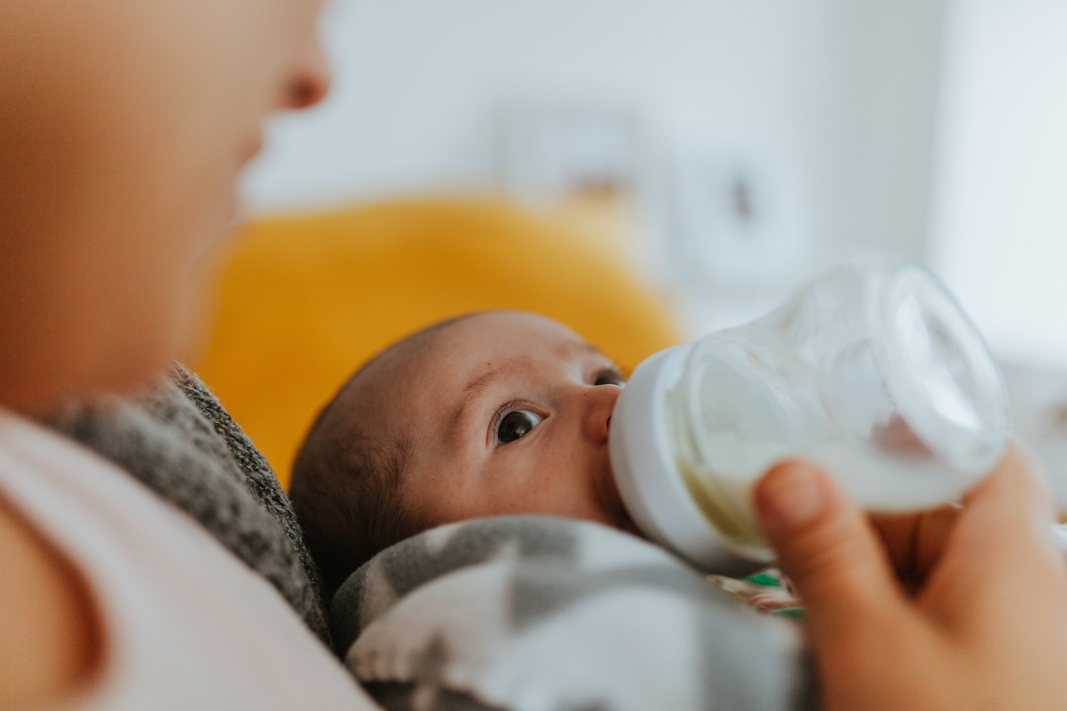 A woman feeding her baby